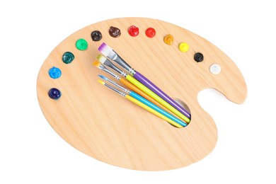 Photo of Palette with paints and brushes on white background, top view. Artist equipment
