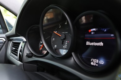 Photo of Speedometer and tachometer inside of modern car, closeup