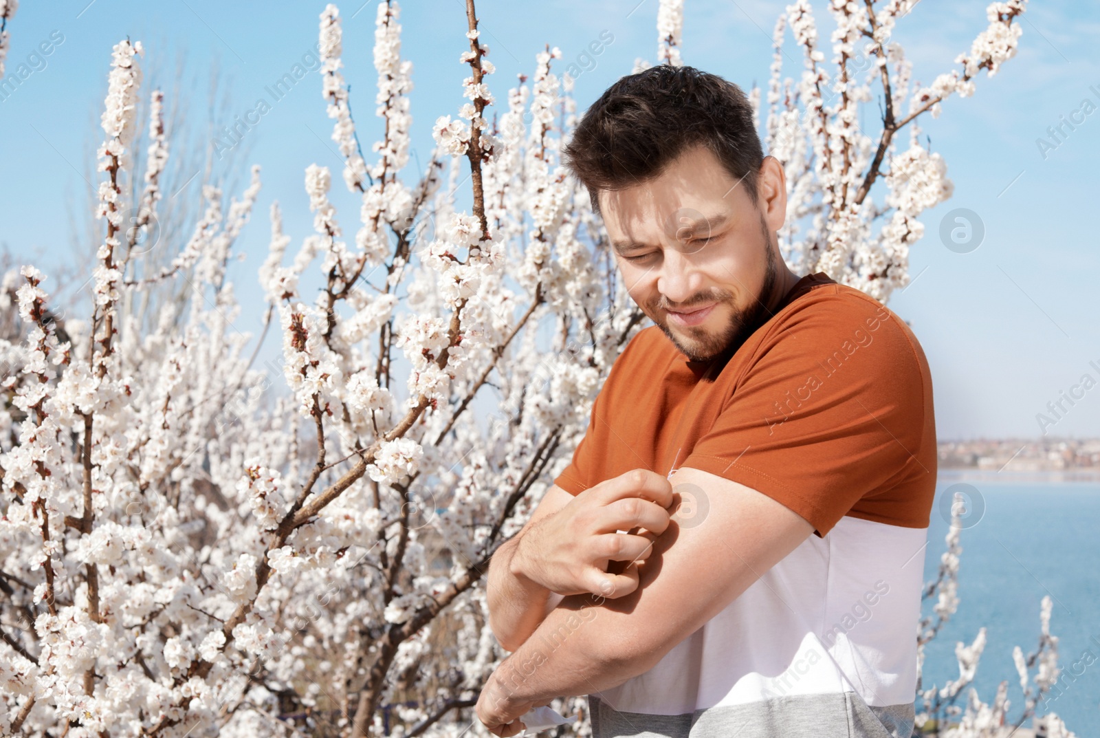 Photo of Man suffering from seasonal allergy outdoors, space for text