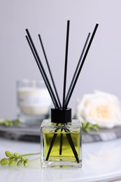 Photo of Aromatic reed air freshener on white table