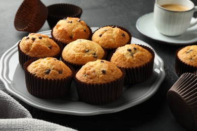 Delicious freshly baked muffins with chocolate chips on table, closeup