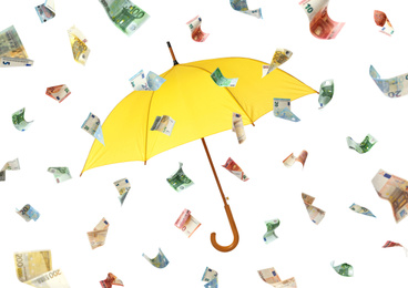 Image of Yellow umbrella and money rain on white background 