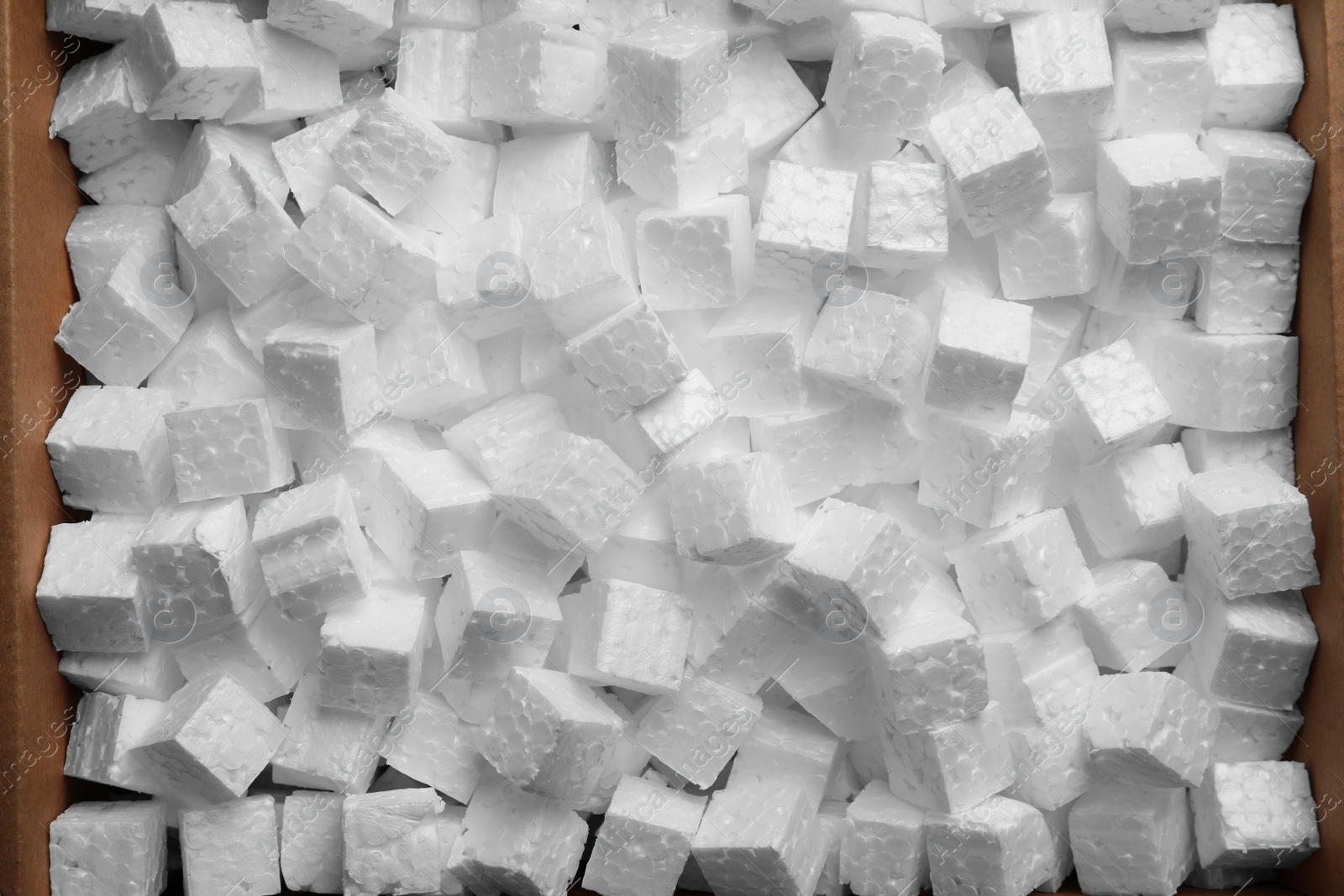 Photo of Cardboard box filled with polystyrene styrofoam pieces, top view