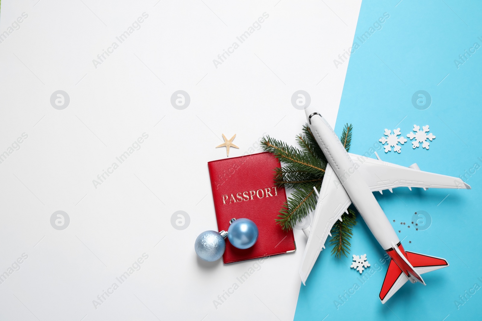 Photo of Flat lay composition with Christmas decorations and passport on color background, space for text. Winter vacation