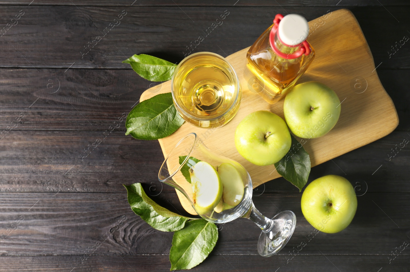 Photo of Flat lay composition with delicious apple cider on wooden table, space for text