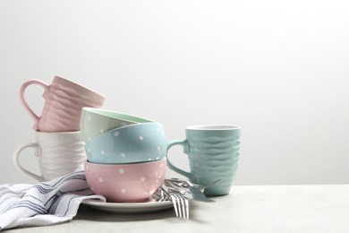 Photo of Beautiful ceramic dishware, cups and cutlery on light grey table