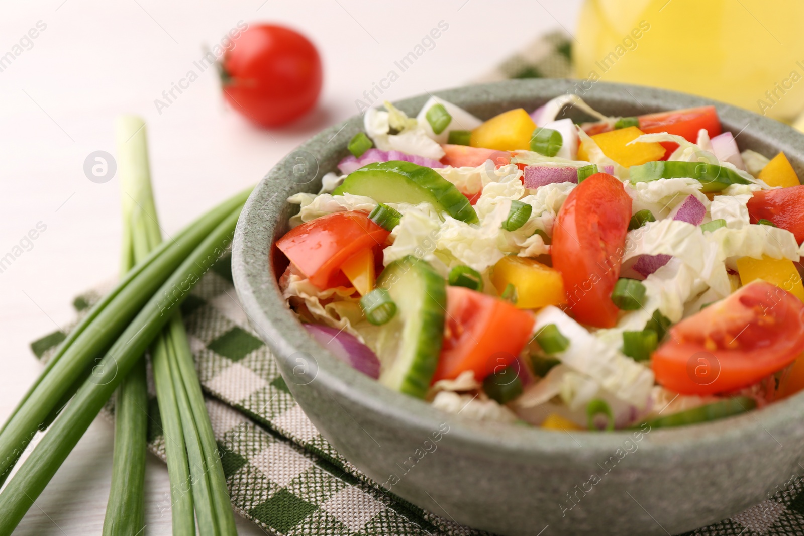 Photo of Tasty salad with Chinese cabbage in bowl on table, closeup