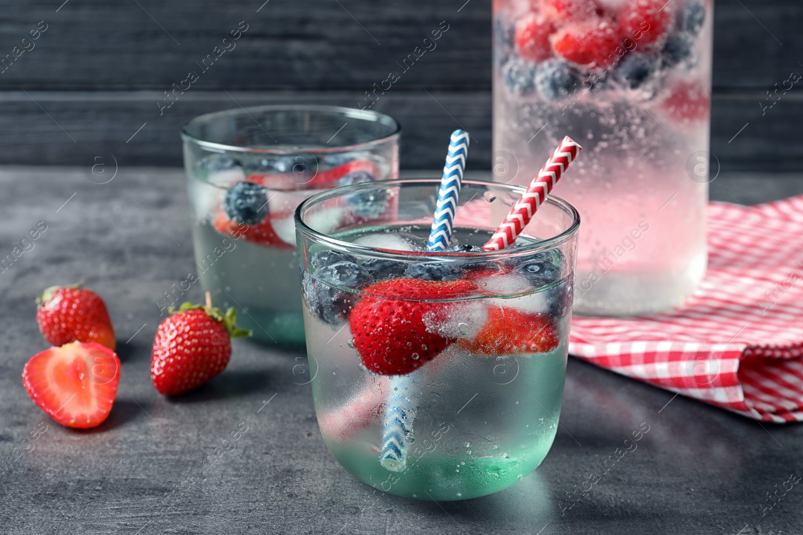 Photo of Glasses of natural lemonade with berries on table