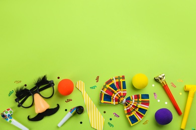 Photo of Flat lay composition with clown's accessories on green background. Space for text