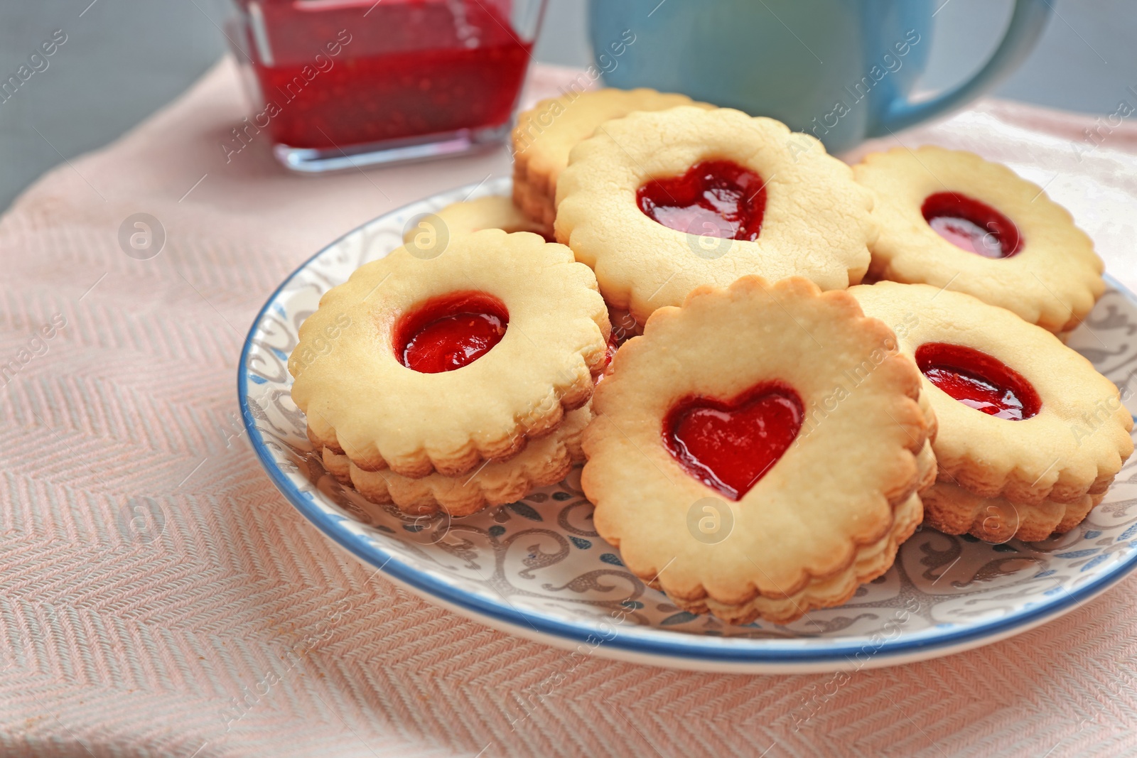 Photo of Traditional Christmas Linzer cookies with sweet jam on plate