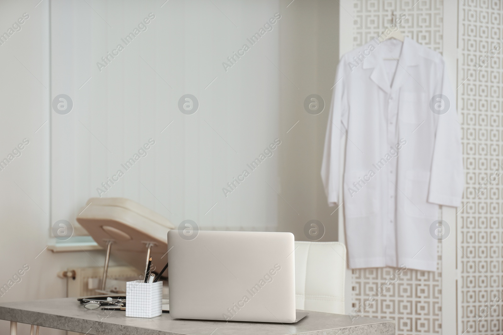 Photo of Doctor's workplace with laptop in modern clinic