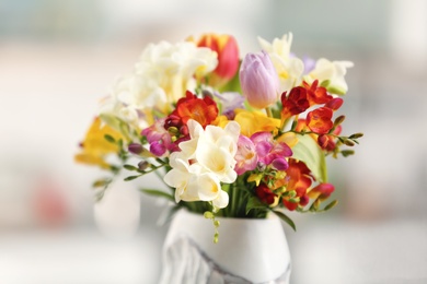 Beautiful bouquet of freesia flowers on blurred background