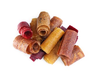 Delicious fruit leather rolls on white background, top view