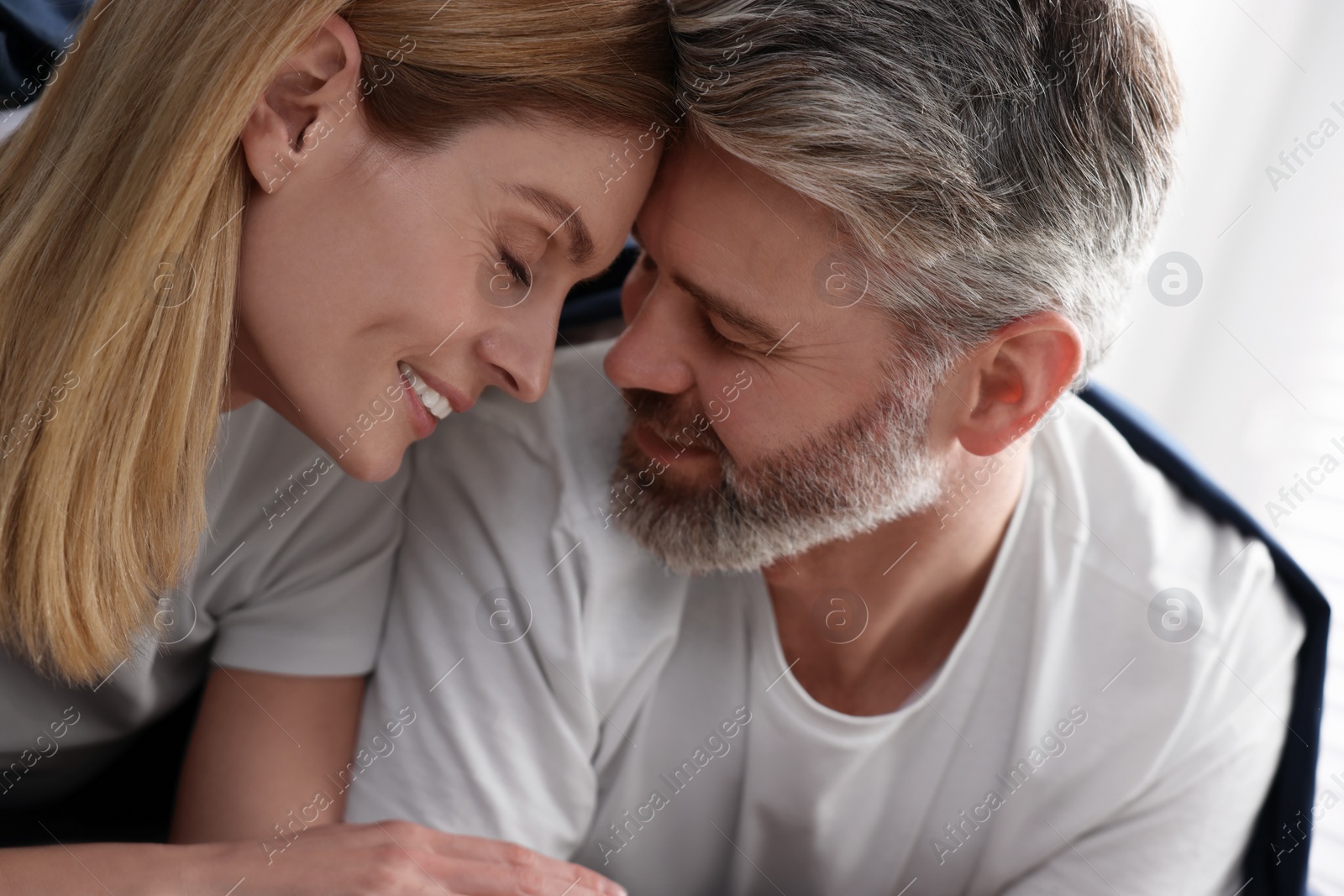 Photo of Lovely mature couple in bed at home, closeup