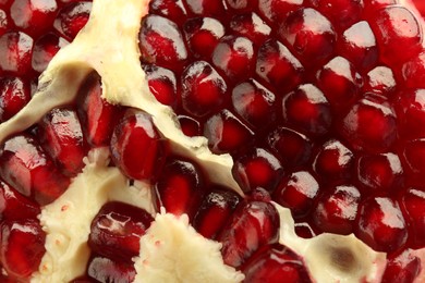 Photo of Ripe juicy pomegranate grains as background, closeup