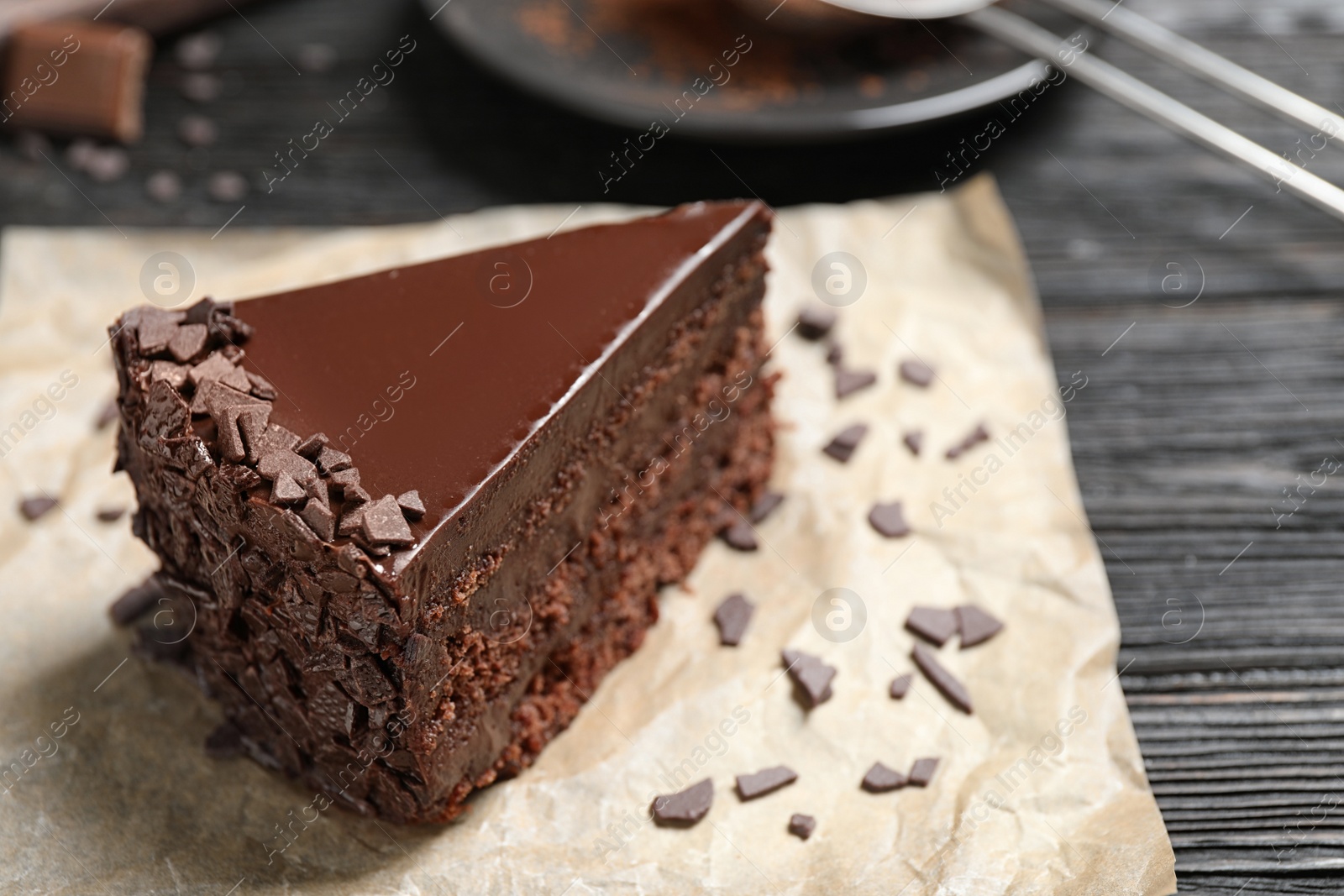 Photo of Delicious fresh chocolate cake on wooden table, closeup