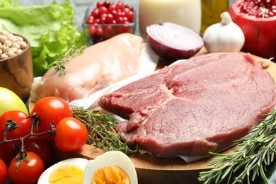 Photo of Fresh meat and other products for balanced diet on table
