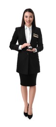 Happy young receptionist in uniform holding service bell on white background