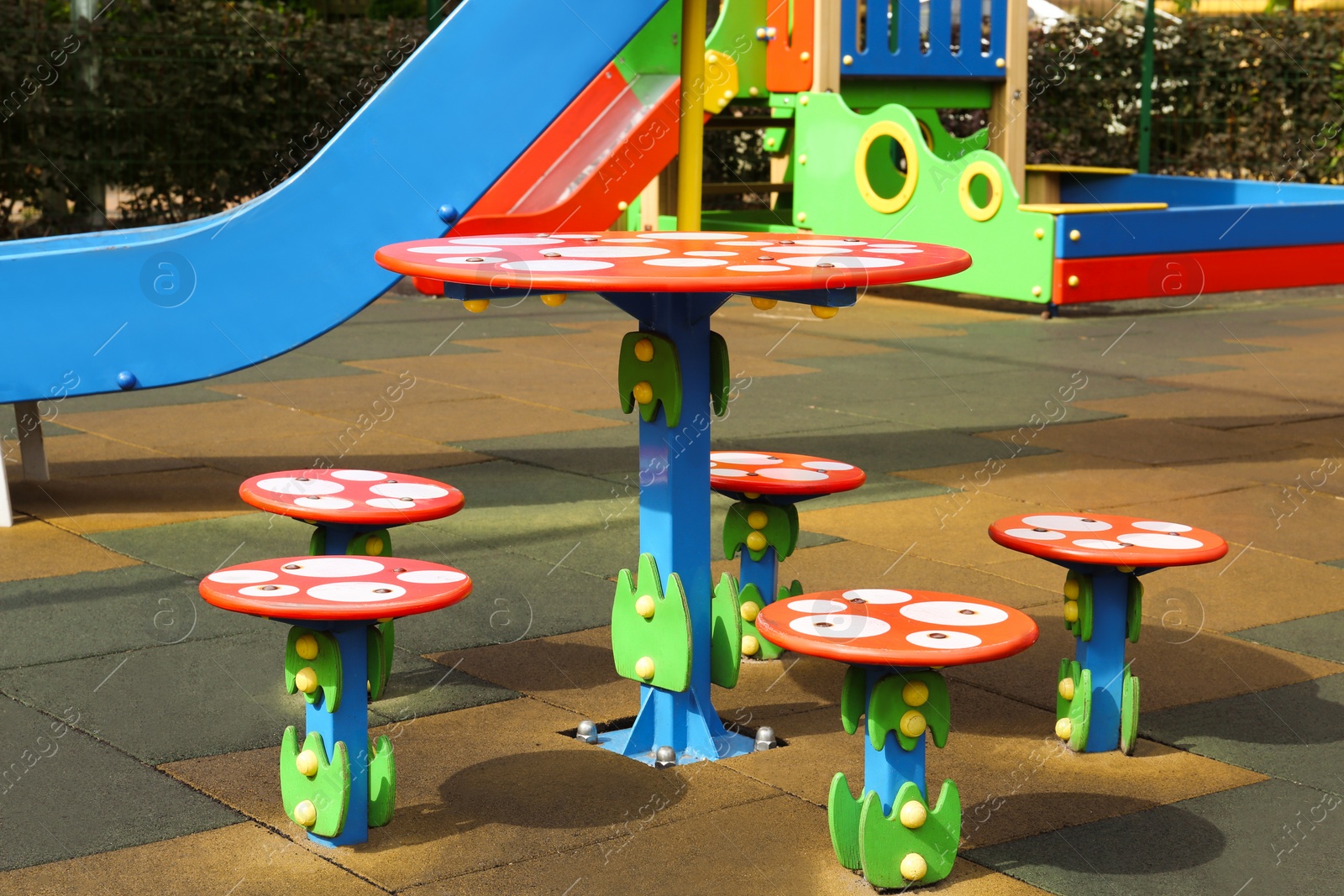 Photo of Outdoor playground for children with funny colorful table and chairs