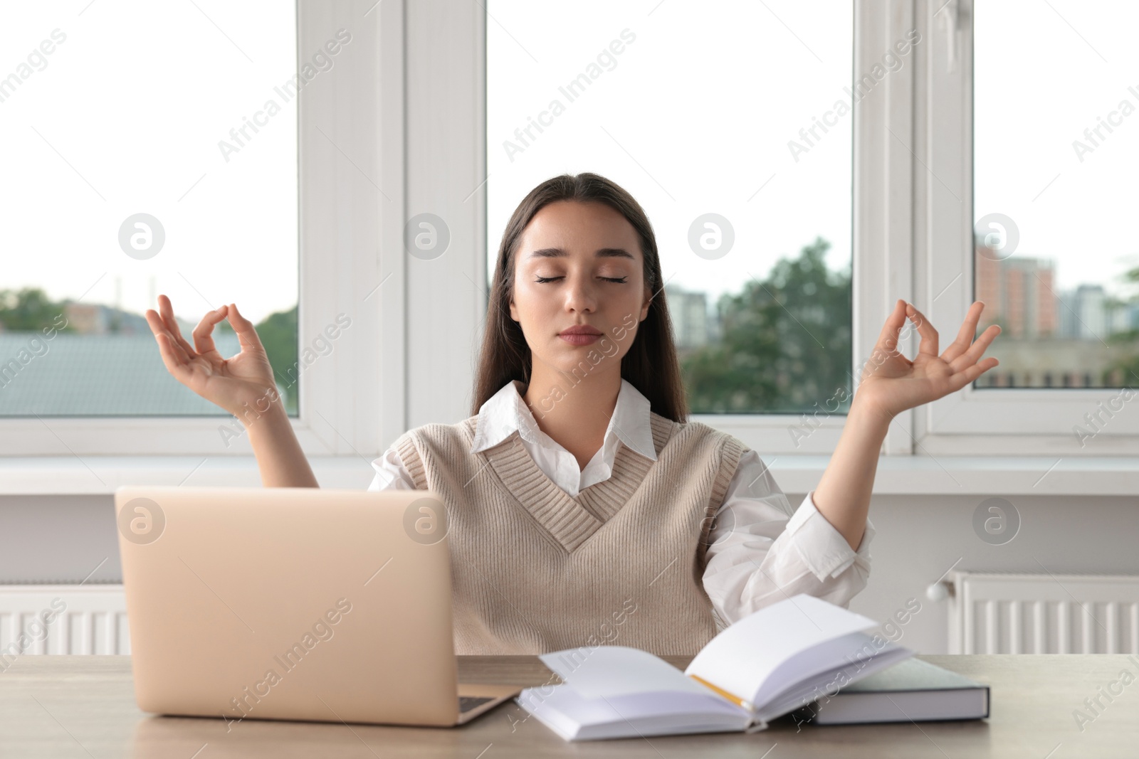 Photo of Find zen. Woman taking break from work at table in room