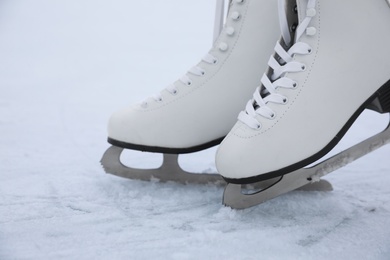 Photo of Figure skates with laces on ice. Winter outdoors activities