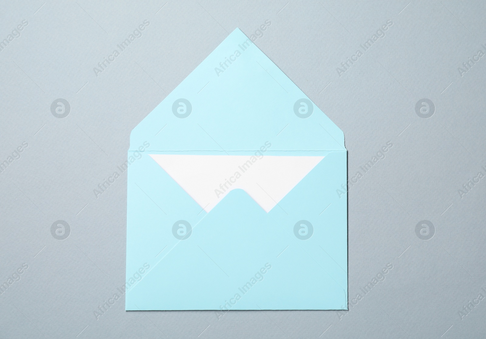 Photo of Letter envelope with card on grey background, top view