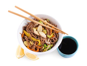 Photo of Stir-fry. Delicious cooked noodles with chicken in bowl, soy sauce, lemon and chopsticks isolated on white, top view