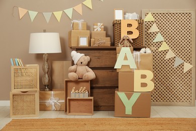 Photo of Gift boxes and toys in room decorated for baby shower party