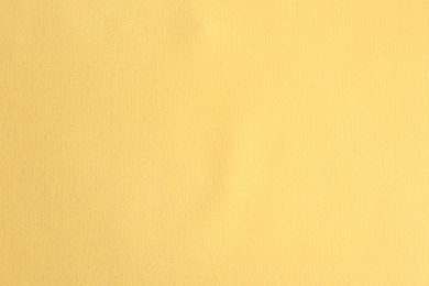 Photo of Texture of beautiful yellow fabric as background, closeup
