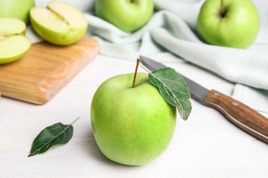 Photo of Fresh ripe green apples on white wooden table, space for text