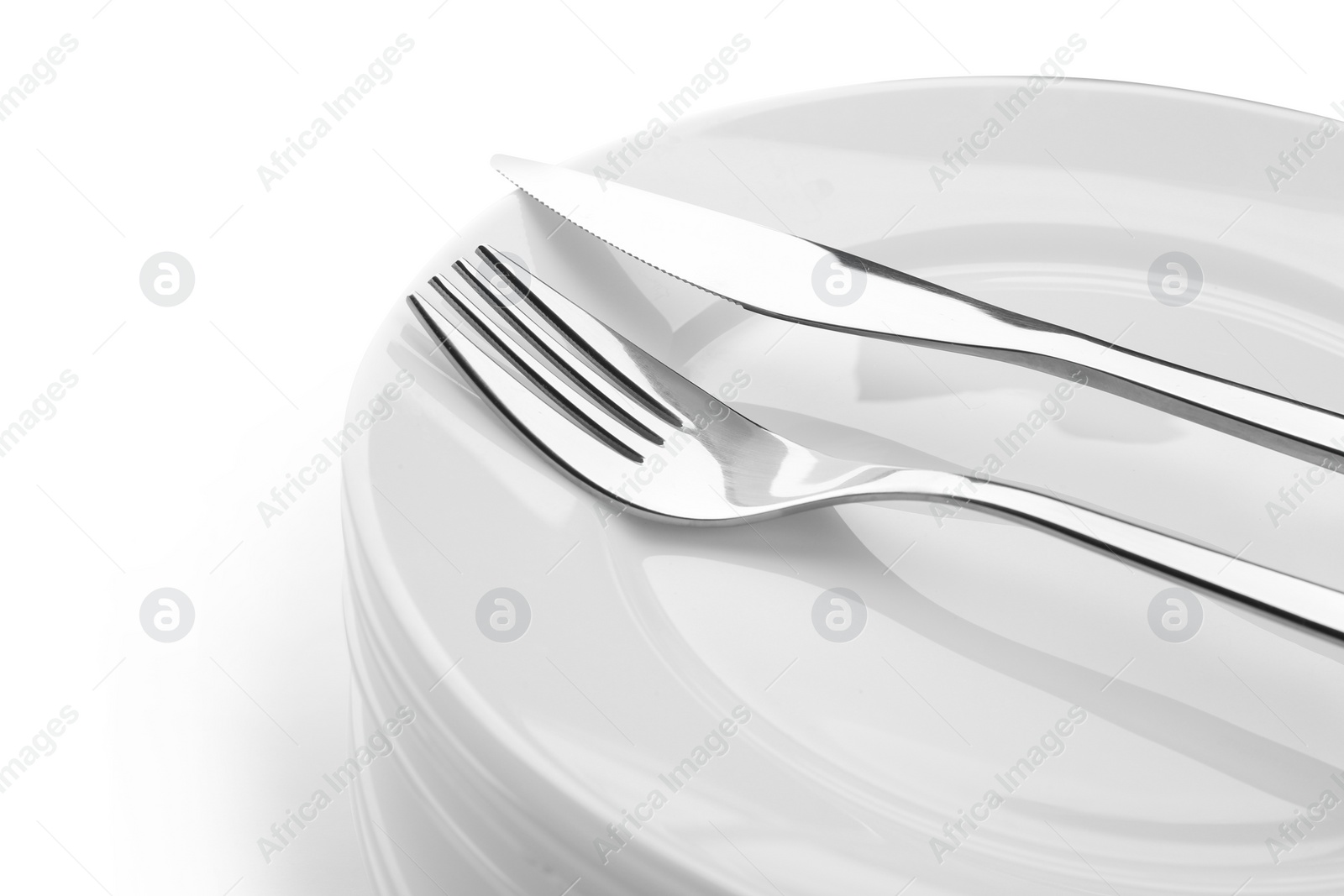 Photo of Stack of plates with fork and knife, closeup