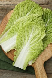 Fresh leaves of Chinese cabbage on wooden table, top view