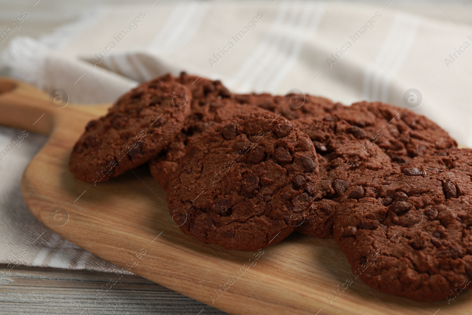 Photo of Delicious chocolate chip cookies on wooden table, closeup