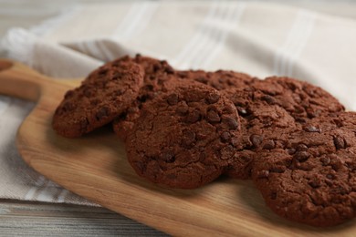 Photo of Delicious chocolate chip cookies on wooden table, closeup