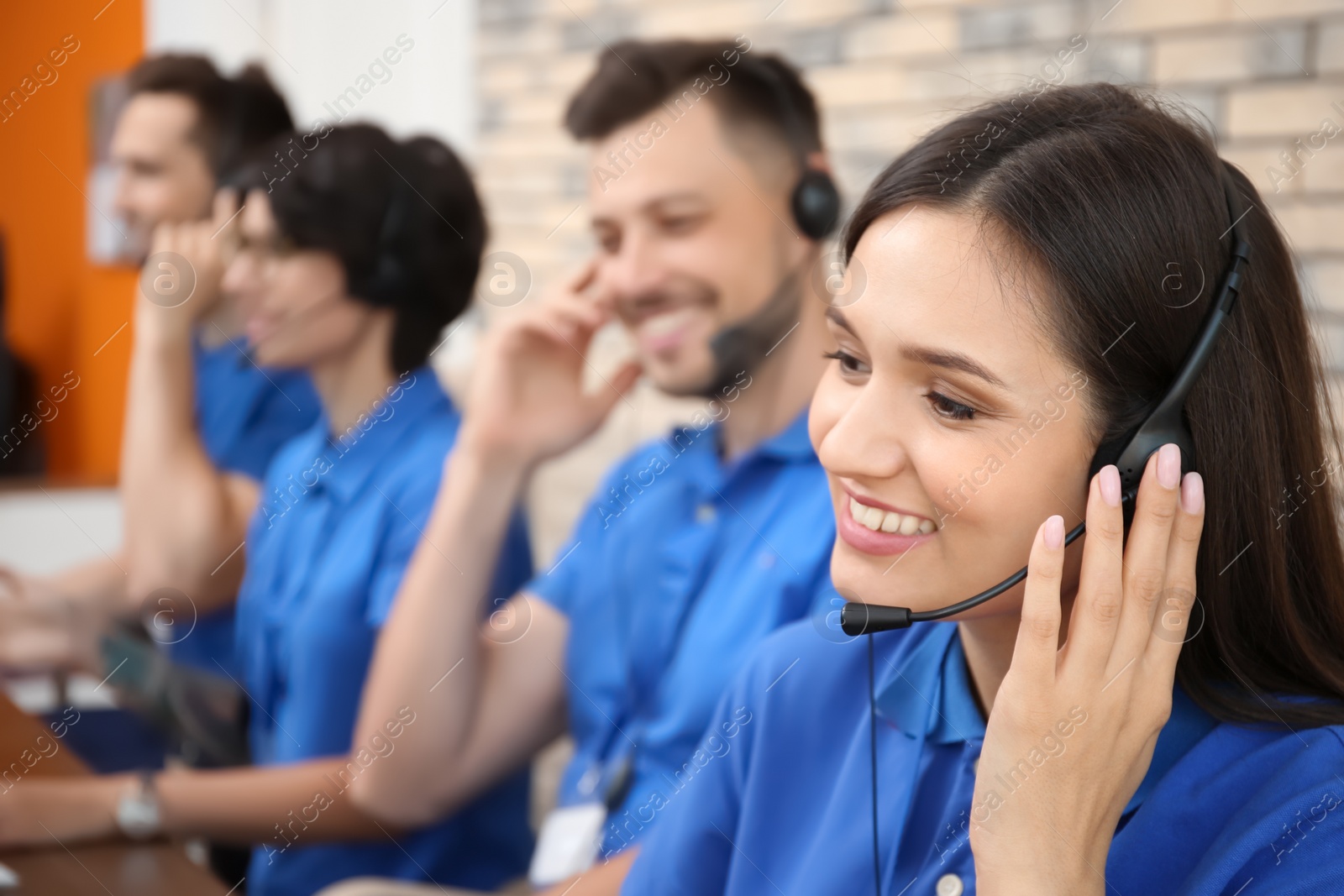 Photo of Technical support operators with headsets at workplace