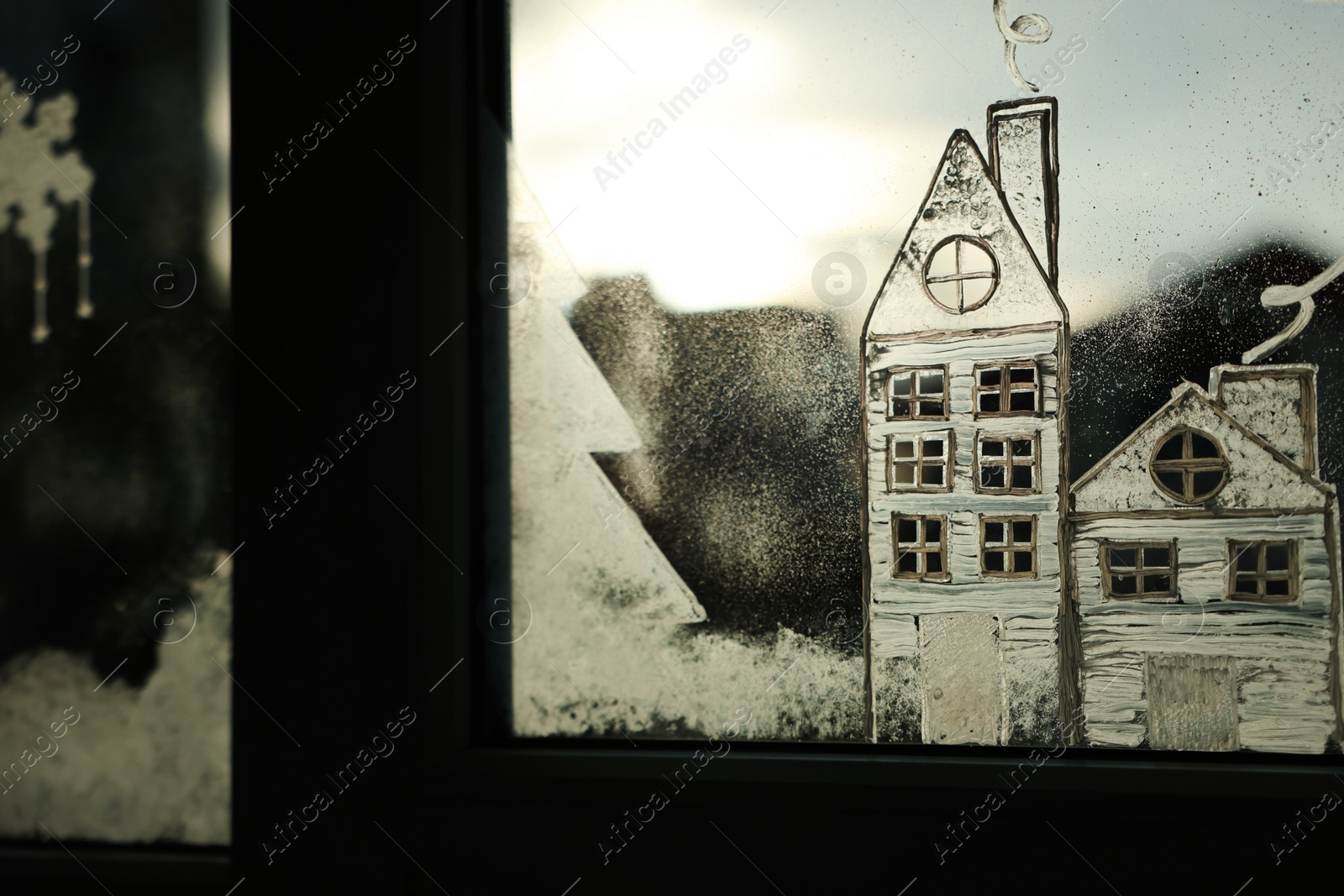 Photo of Beautiful drawing made with artificial snow on window. Christmas decor