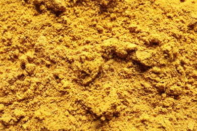 Photo of Dry curry powder as background, top view