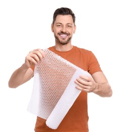 Photo of Man holding roll of bubble wrap on white background. Stress relief