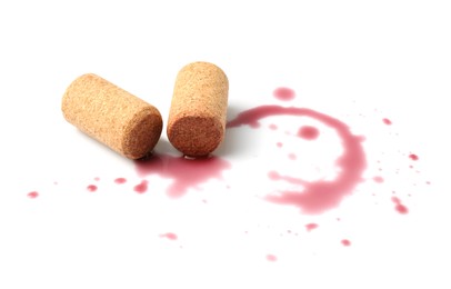 Photo of Bottle corks with wine stains on white background