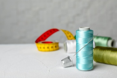 Color sewing thread with needle on table