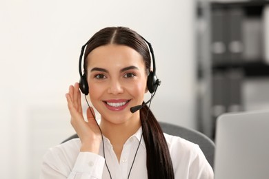 Photo of Hotline operator with headset working in office