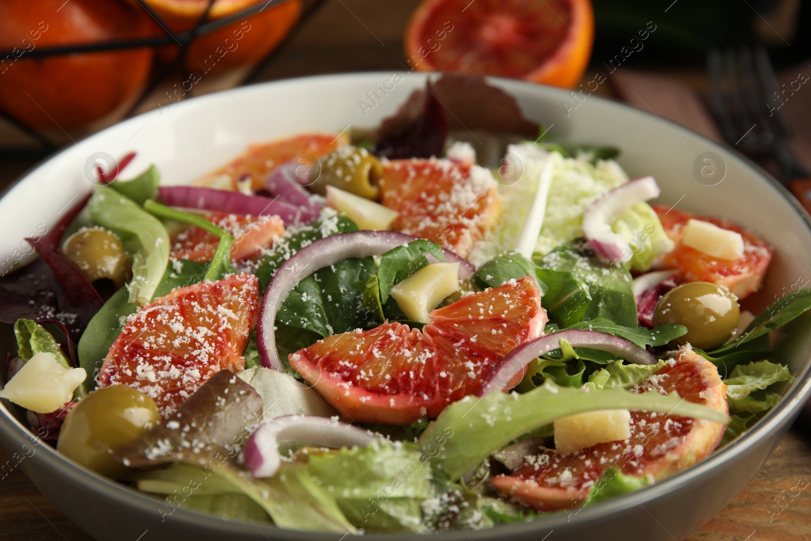 Photo of Bowl of delicious sicilian orange salad on table, closeup