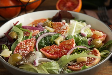 Photo of Bowl of delicious sicilian orange salad on table, closeup