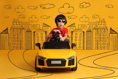 Image of Cute little boy with his dog in toy car and drawing of city on yellow background