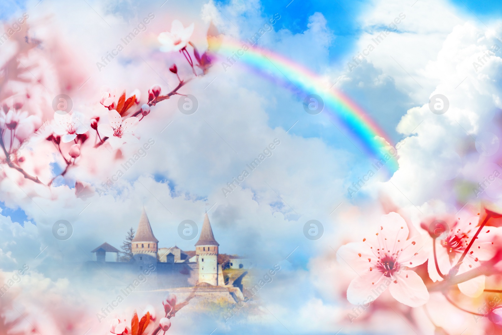 Image of Fantasy world. Beautiful rainbow in sky with fluffy clouds over enchanted castle