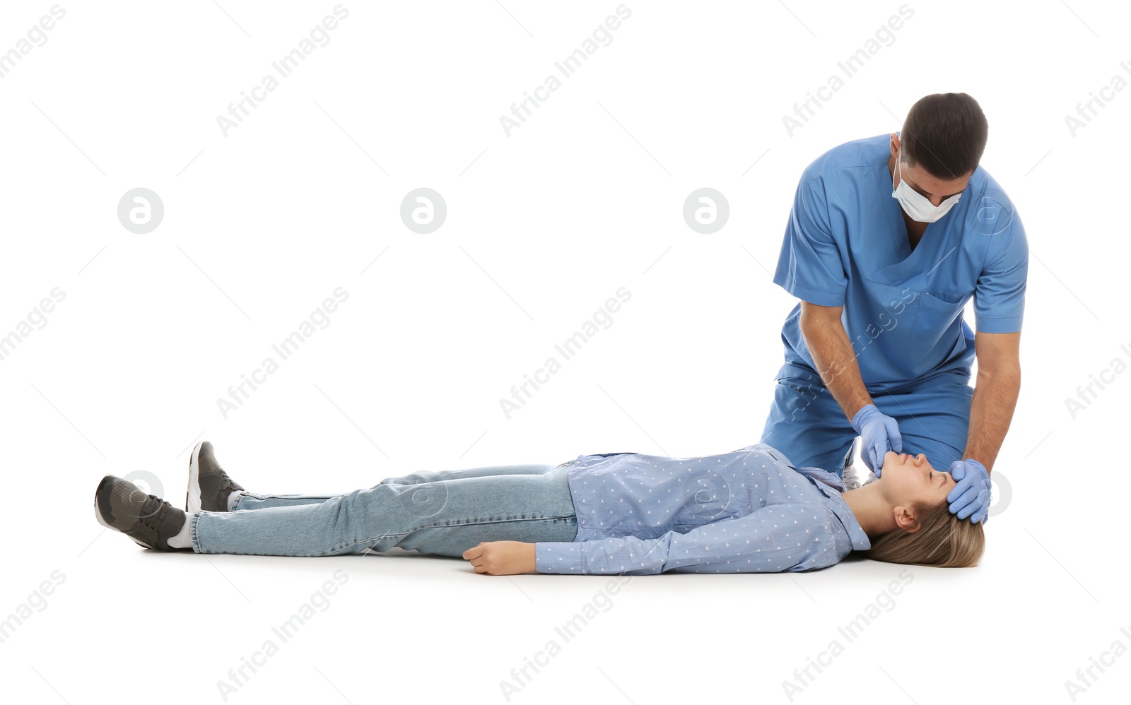 Photo of Doctor in uniform practicing first aid on woman against white background