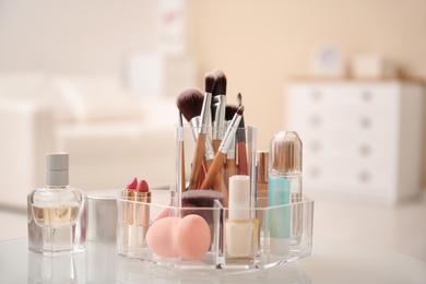 Makeup cosmetic products and tools in organizer on dressing table