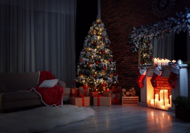 Stylish room interior with beautiful Christmas tree in evening