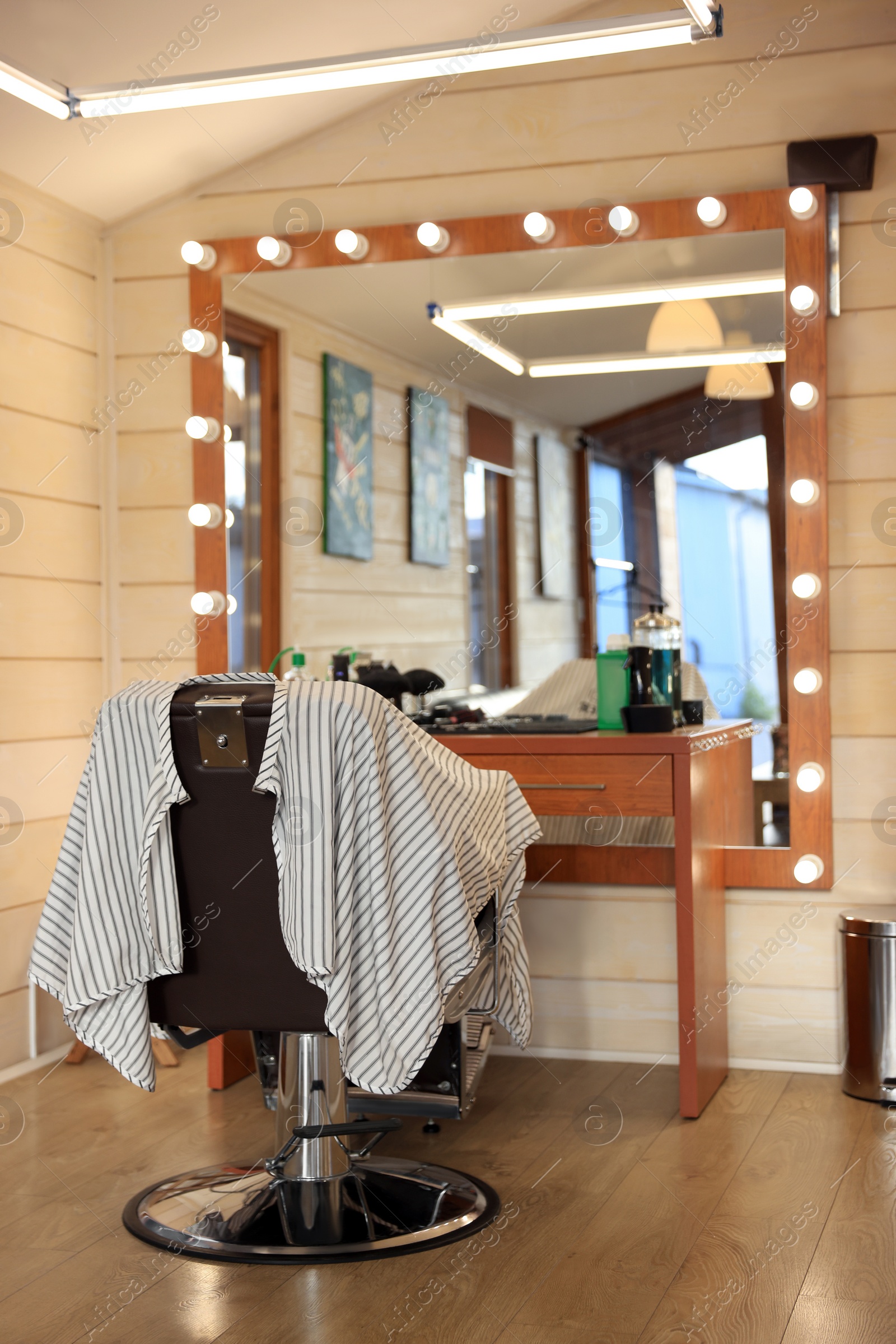 Photo of Stylish hairdresser's workplace with professional armchair in barbershop