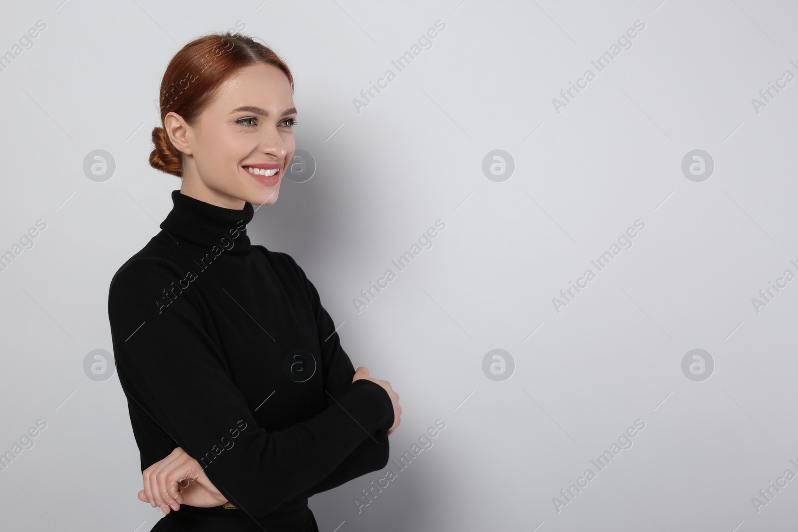 Photo of Portrait of beautiful young woman on light gray background, space for text